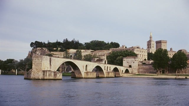 Avignon's famous bridge on the mighty Rhone river with the palace of the Popes